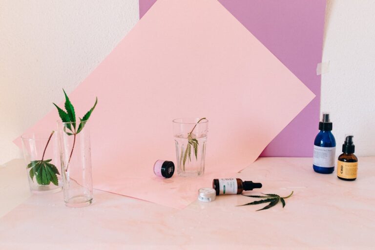 Artistic still life of CBD products and cannabis leaves, perfect for wellness content.